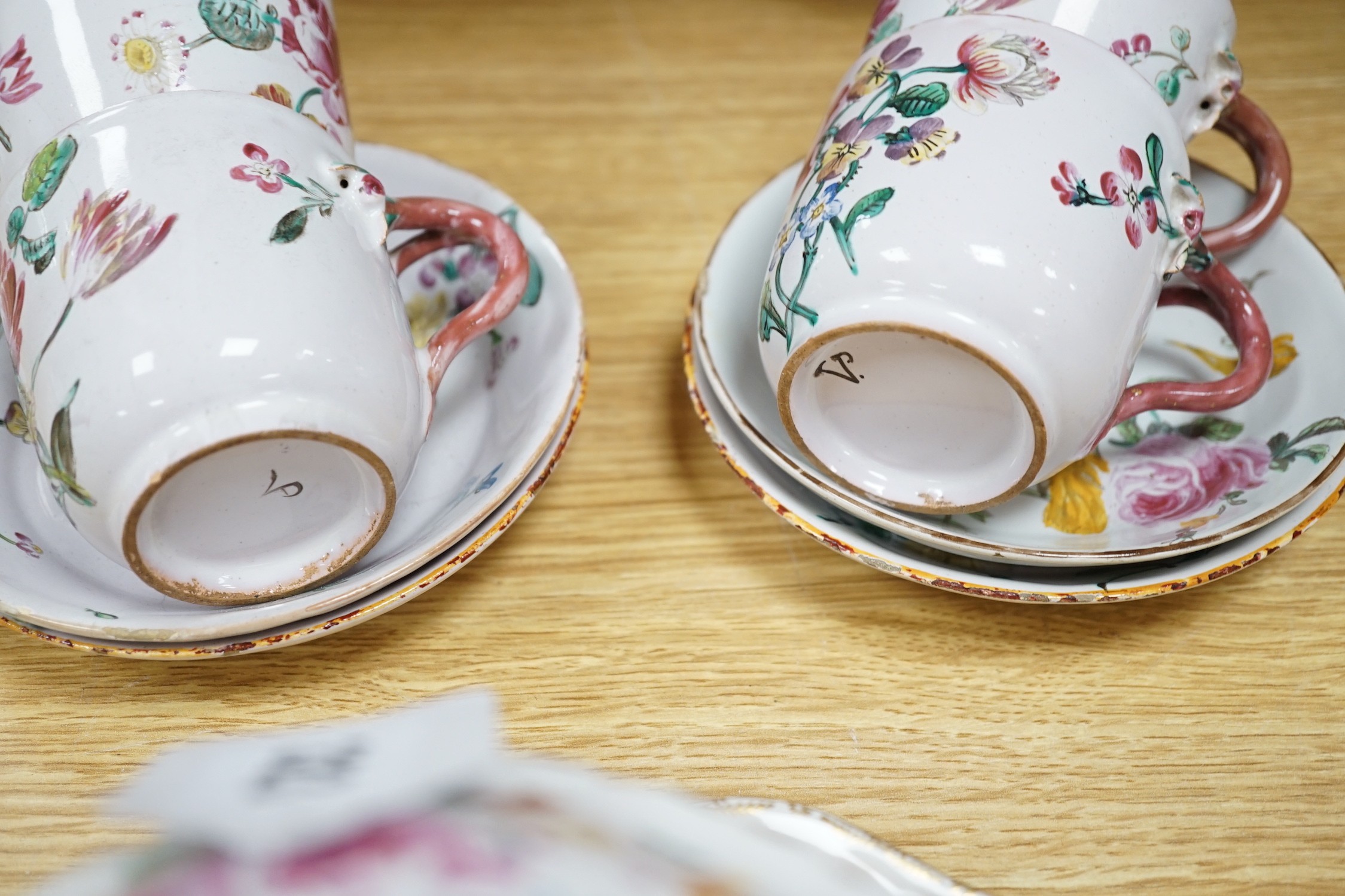 A group of of French faience pottery including a pair of pot pourri vases and covers, a tureen with integral stand, cover, ladle and four coffee cups and saucers